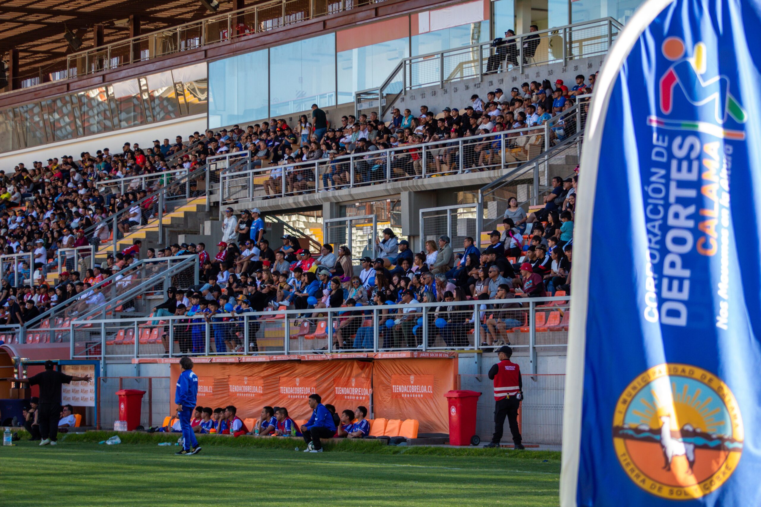 Home Vibrant crowd enjoying an outdoor sports event at a large stadium, Calama.